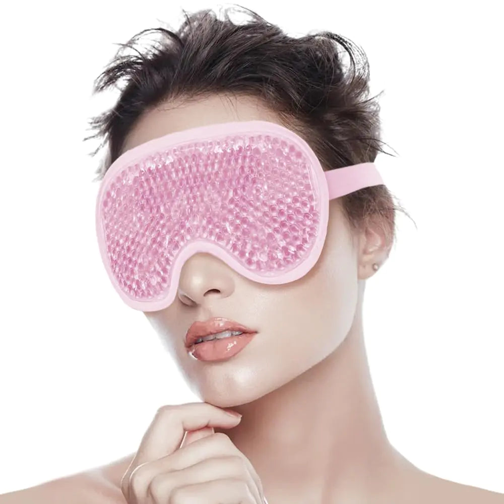 Person wearing a pink eye mask with beads on a white background