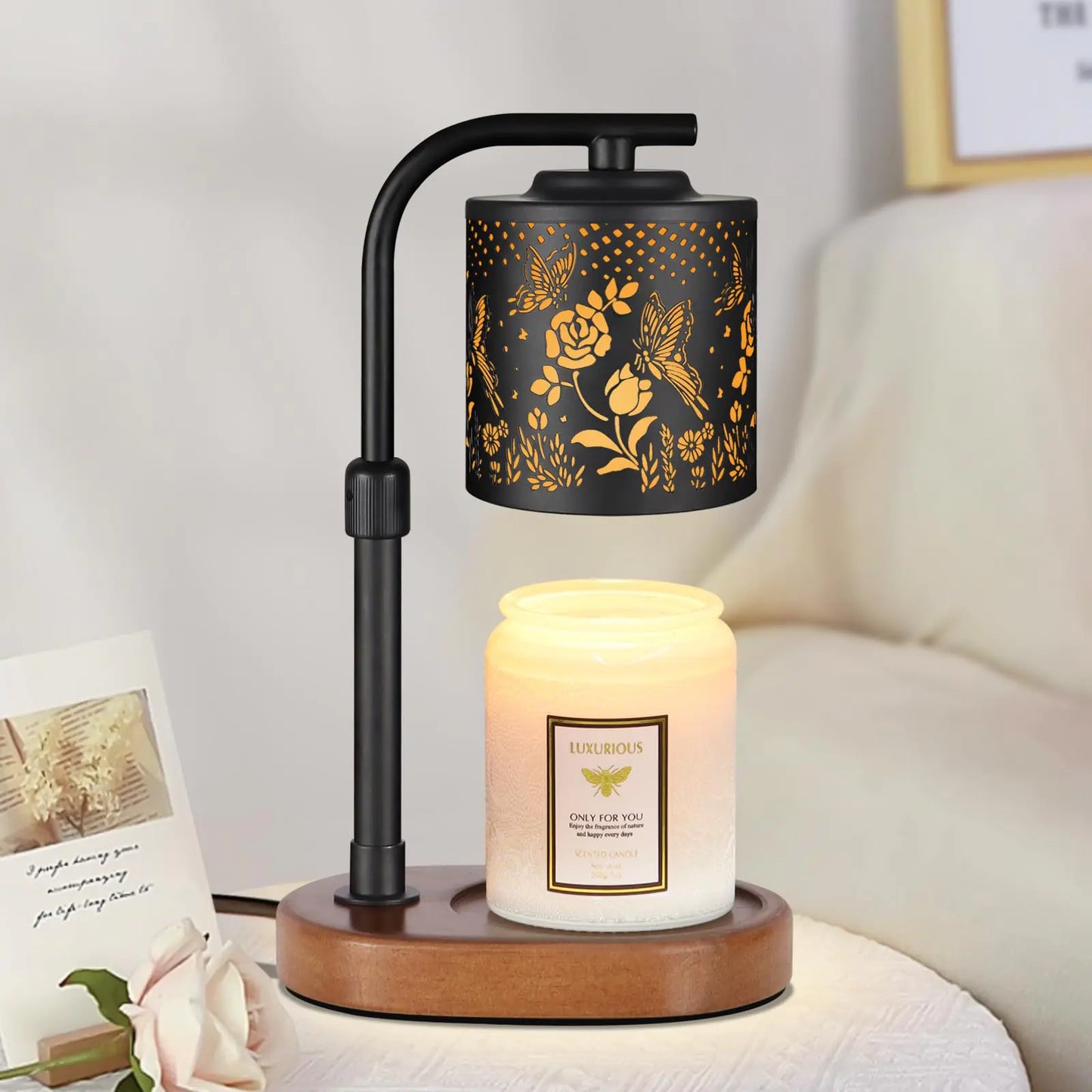 Decorative lamp with floral design and candle on a wooden base.