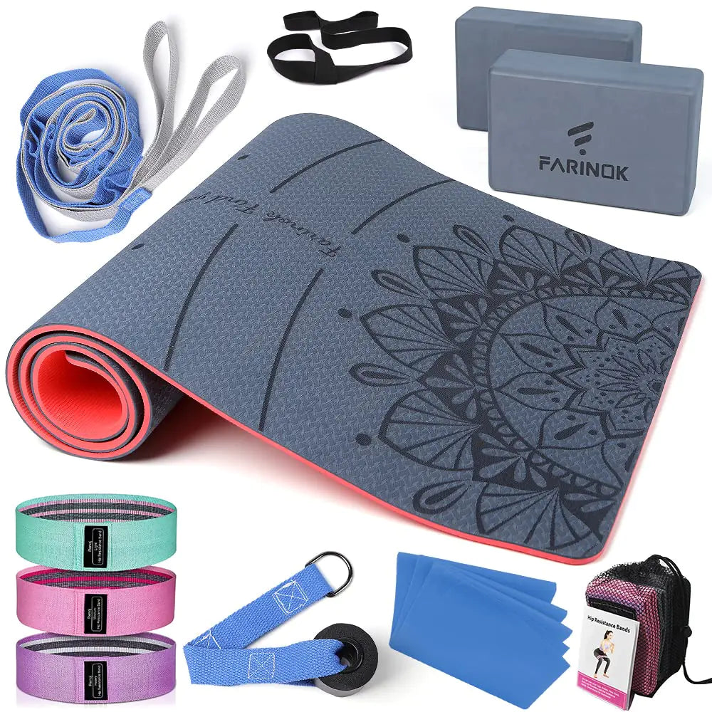 Yoga mat with mandala design, resistance bands, and blocks on a white background