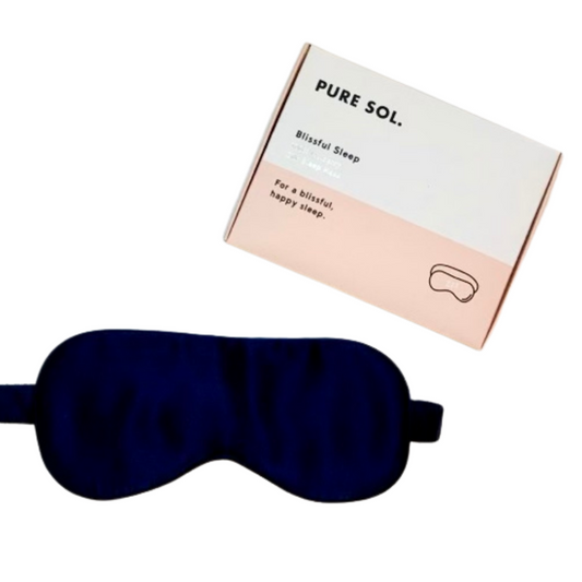 Navy sleep mask with 'PURE SOL.' packaging on a white background