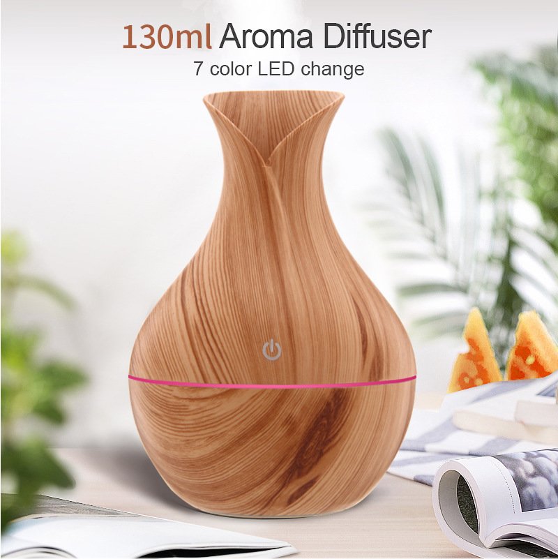 Wooden-patterned aroma diffuser with LED lights on a blurred background