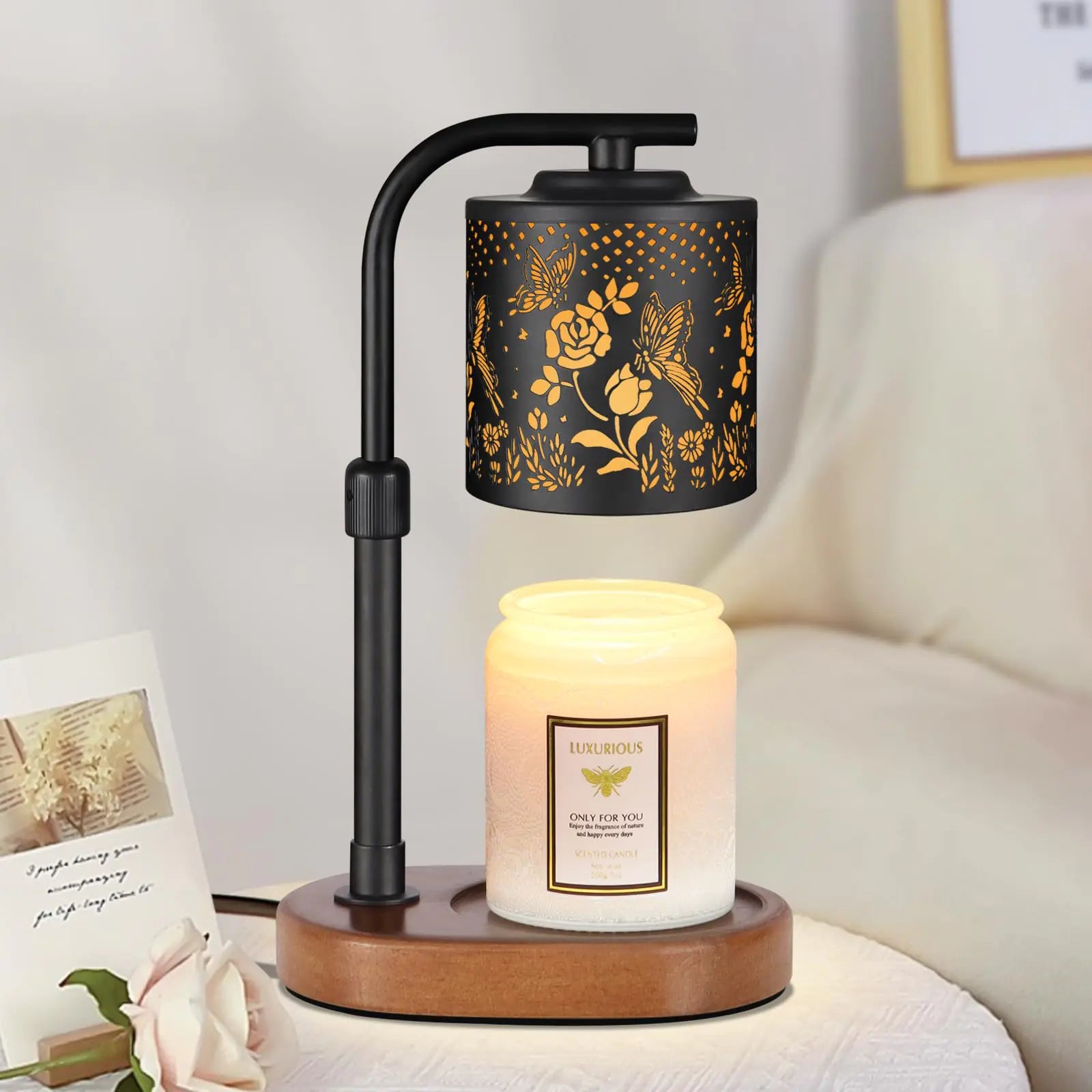Decorative lamp with floral design and candle on a wooden base.